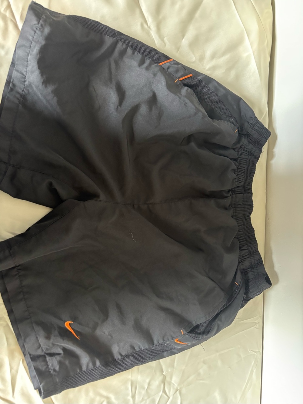 Nike Black Athletic Shorts with Orange Swoosh Accents